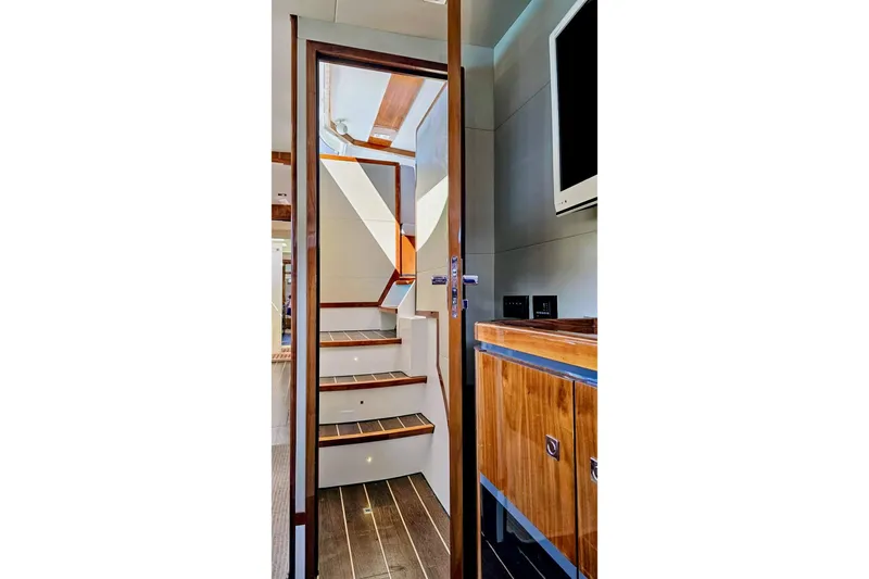  Yacht Photos Pics Interior of 2016 HH Catamarans HH66, featuring sleek wooden stairs and modern design elements.