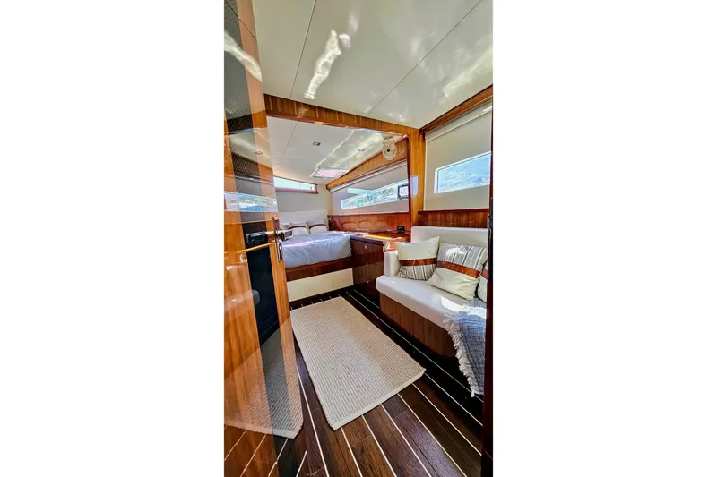  Yacht Photos Pics Luxurious interior of 2016 HH Catamarans HH66, featuring elegant wood finishes and cozy seating.