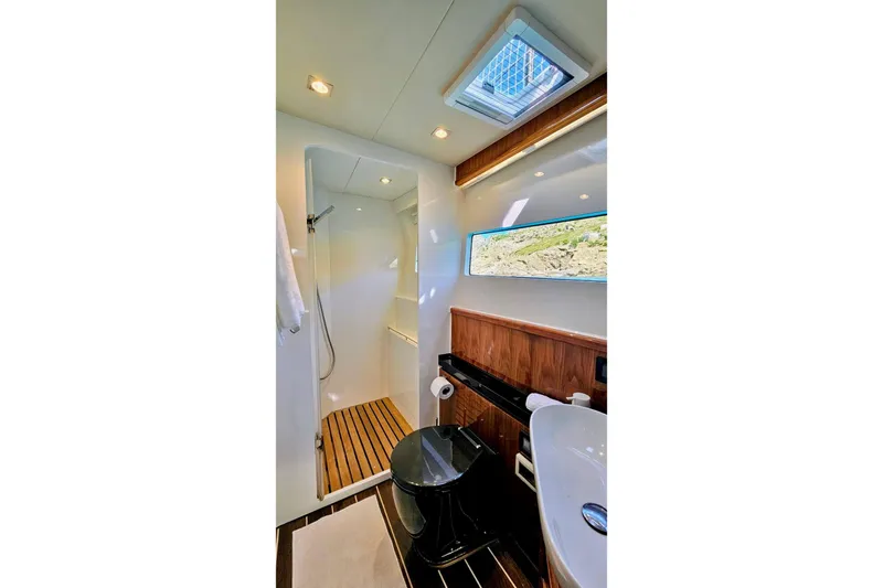  Yacht Photos Pics Luxurious bathroom interior of 2016 HH Catamarans HH66 with modern fixtures and scenic window view.
