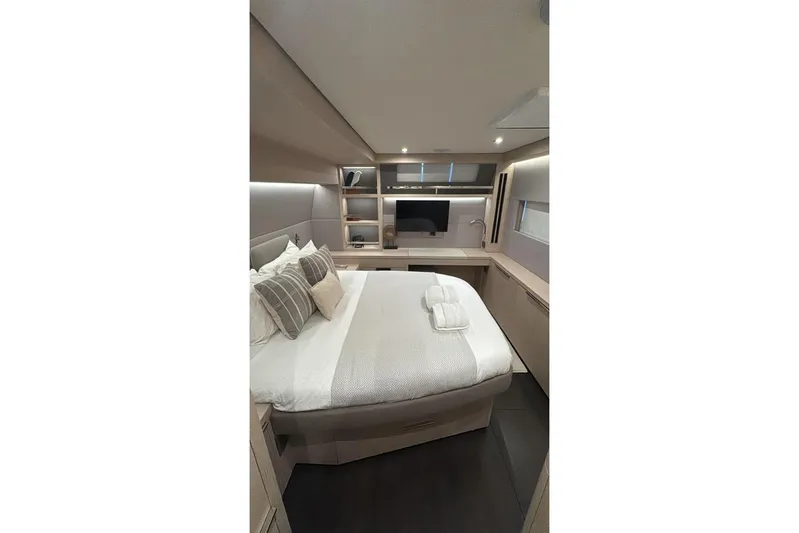 Va Bene Yacht Photos Pics Luxurious interior cabin of 2022 Lagoon 55 yacht with modern design and cozy bedding.