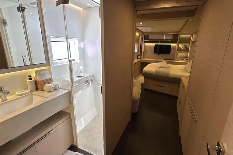 Va Bene Yacht Photos Pics Luxurious interior of 2022 Lagoon 55 yacht featuring modern bathroom and cozy bedroom.
