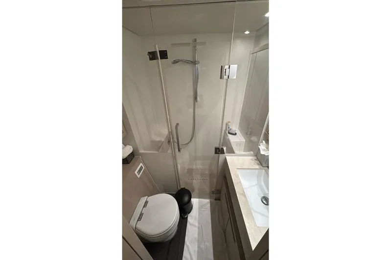 Va Bene Yacht Photos Pics Modern bathroom in 2022 Lagoon 55 yacht with shower, toilet, and sink.