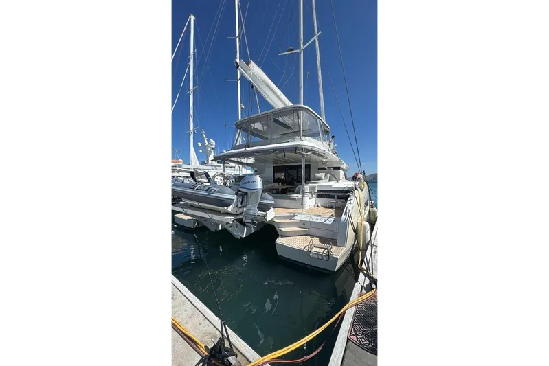 Va Bene Yacht Photos Pics Luxury Lagoon 55 yacht docked, 2022 model, with clear blue sky background.