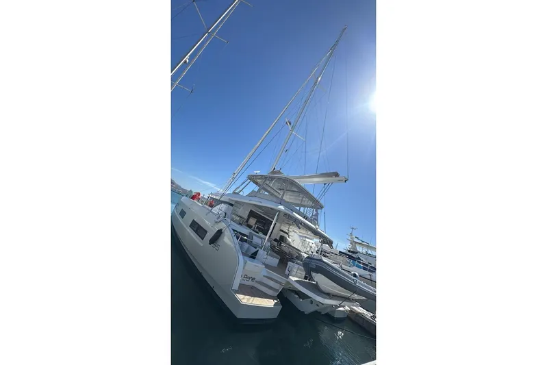 Va Bene Yacht Photos Pics 2022 Lagoon 55 yacht docked under clear blue sky.