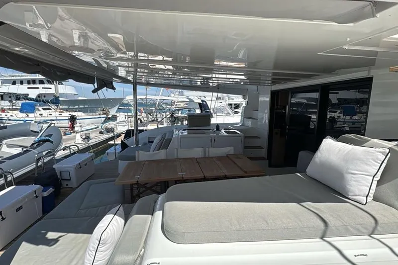 Va Bene Yacht Photos Pics Luxurious 2022 Lagoon 55 yacht interior with spacious seating and marina view.