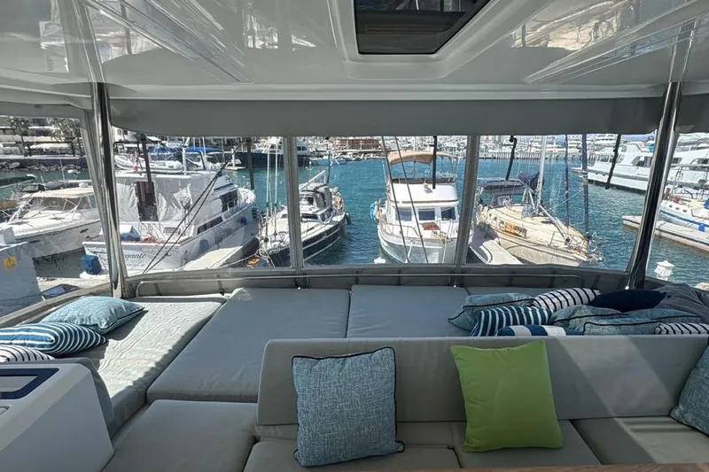 Va Bene Yacht Photos Pics Interior view of 2022 Lagoon 55 yacht with marina backdrop.