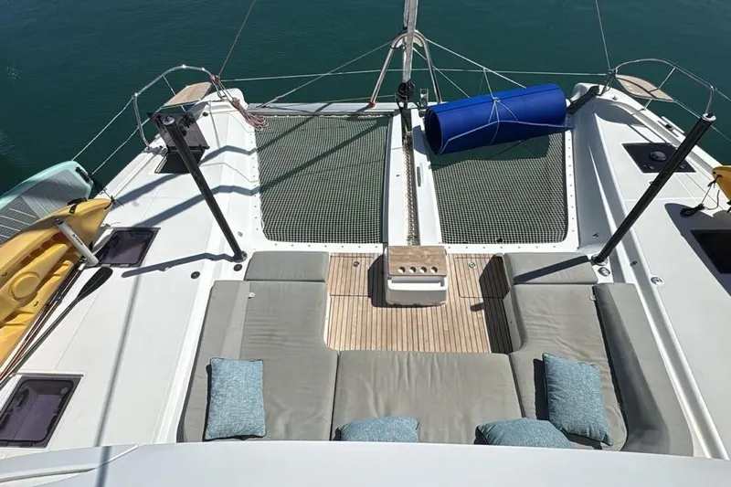 Va Bene Yacht Photos Pics 2022 Lagoon 55 yacht deck with seating, netting, and kayak storage.