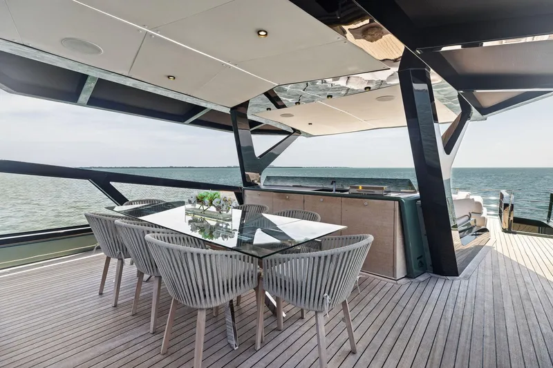 Matzu II Yacht Photos Pics Luxurious 2023 Wally WHY 150 yacht deck with elegant dining area and ocean view.