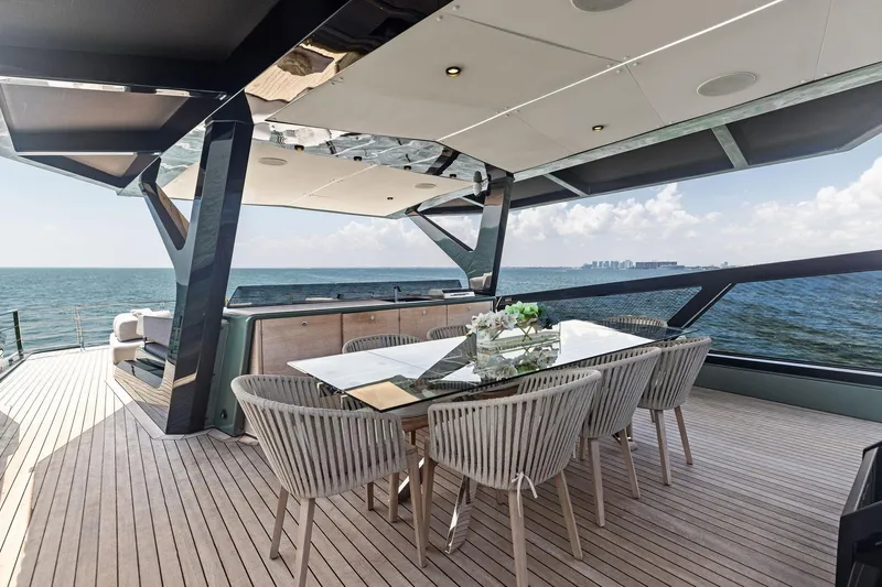 Matzu II Yacht Photos Pics Luxurious 2023 Wally WHY 150 yacht with elegant outdoor dining area overlooking the ocean.