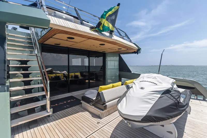 Matzu II Yacht Photos Pics Luxurious 2023 Wally WHY 150 yacht deck with seating, stairs, and jet ski.