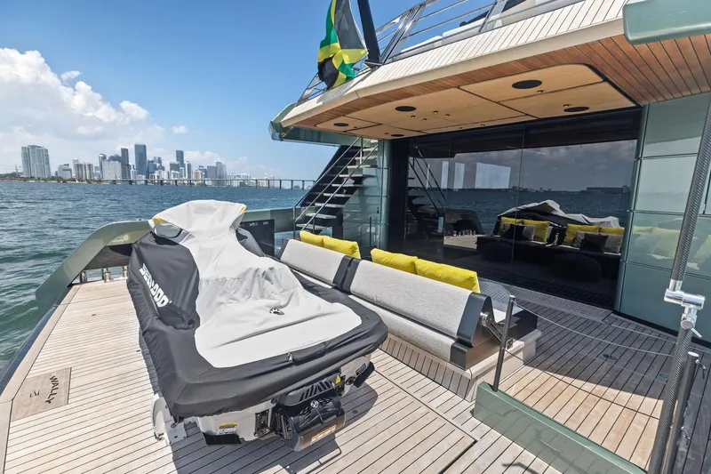 Matzu II Yacht Photos Pics Luxurious 2023 Wally WHY 150 yacht deck with city skyline view, featuring modern seating and jet ski.