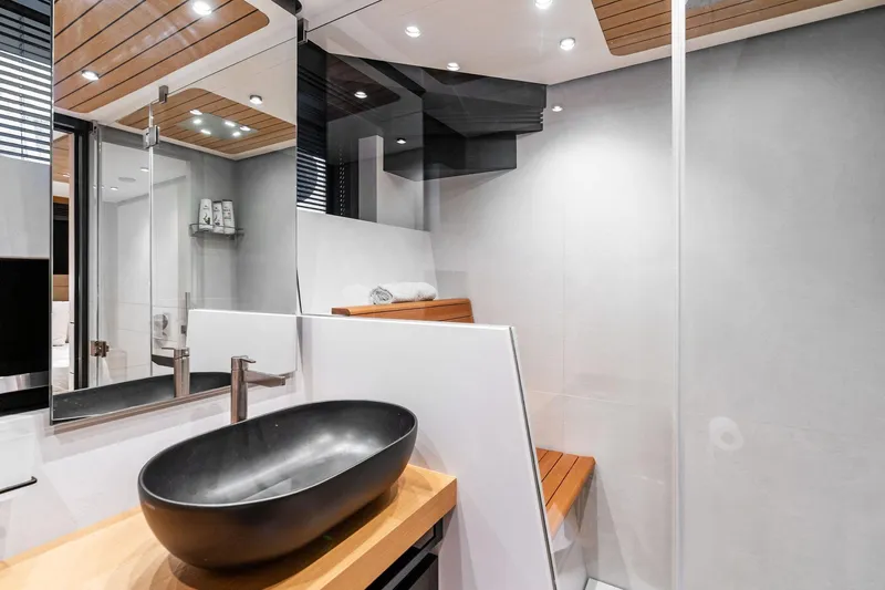 Matzu II Yacht Photos Pics Modern yacht bathroom with sleek black basin, wooden accents, and minimalist design. Wally WHY 150, 2023.