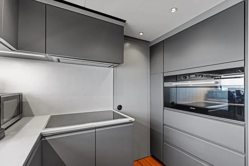 Matzu II Yacht Photos Pics Modern kitchen interior in 2023 Wally WHY 150 yacht, featuring sleek gray cabinetry and appliances.