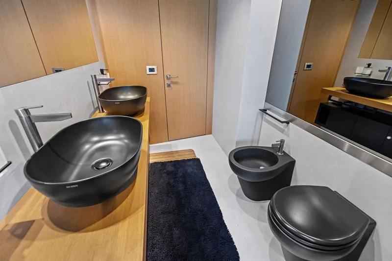 Matzu II Yacht Photos Pics Modern bathroom with black fixtures, wooden accents, and sleek design in a 2023 Wally WHY 150.