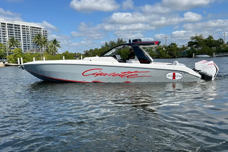  Yacht Photos Pics 2025 Cigarette 41 Nighthawk boat on water, sleek design, modern architecture, sunny day.