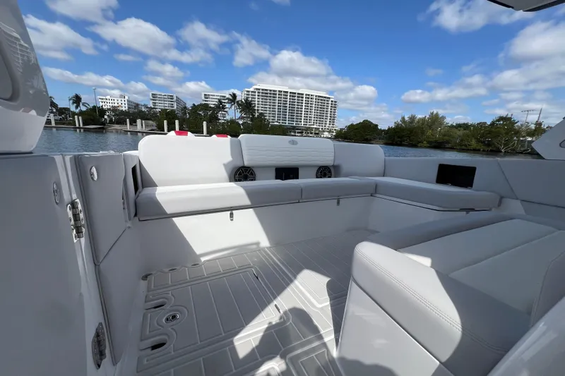  Yacht Photos Pics Luxurious interior of 2025 Cigarette 41 Nighthawk boat with white seating and scenic waterfront view.