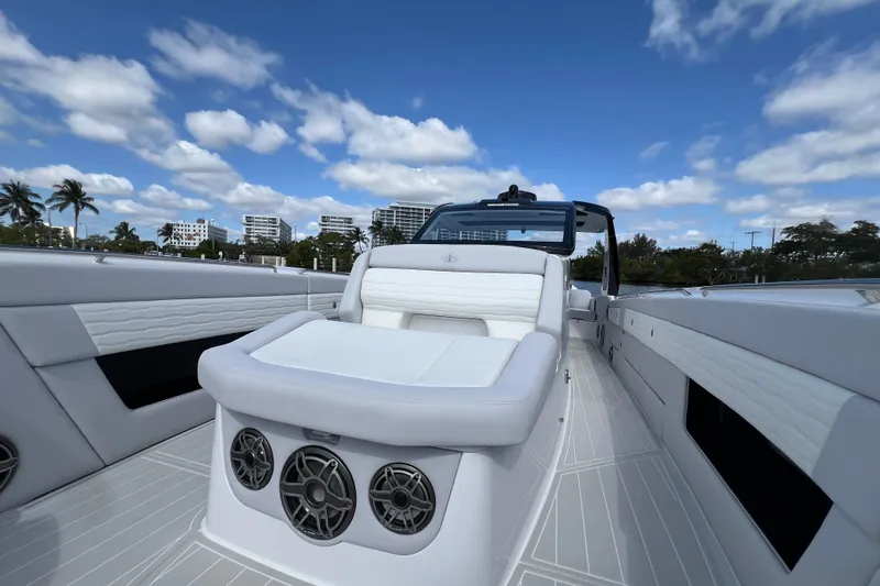  Yacht Photos Pics 2025 Cigarette 41 Nighthawk luxury boat interior with white seating and speakers under blue sky.