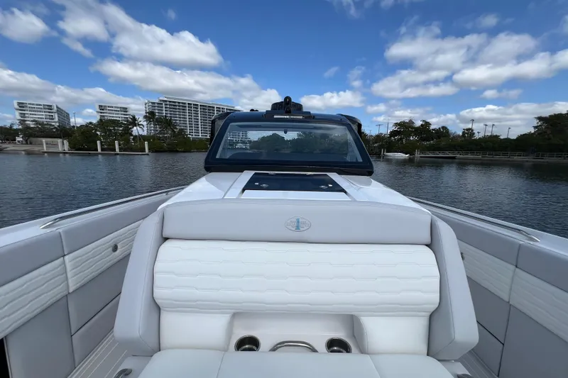  Yacht Photos Pics 2025 Cigarette 41 Nighthawk boat on calm water, modern design, blue sky background.