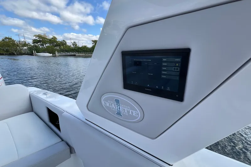  Yacht Photos Pics 2025 Cigarette 41 Nighthawk boat with touchscreen display, docked on a sunny day.