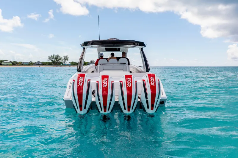  Yacht Photos Pics 2025 Cigarette 41 Nighthawk boat with four powerful engines on clear blue water.