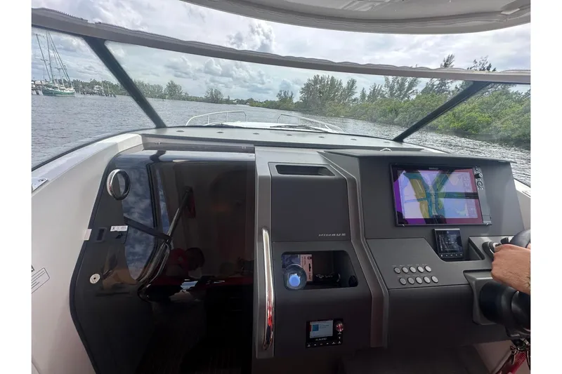  Yacht Photos Pics Interior view of 2025 Nimbus Tender 11 boat with navigation system and steering controls.