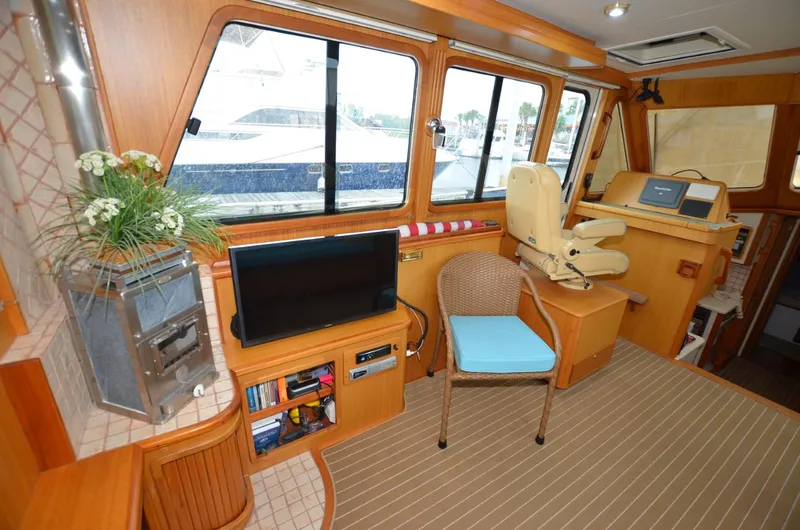 O Henry Yacht Photos Pics Interior of 2006 Legacy Yachts Sedan with helm, seating, and entertainment area.