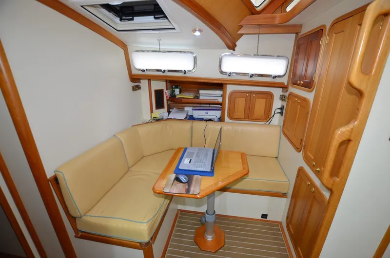 O Henry Yacht Photos Pics 2006 Legacy Yachts Sedan interior with cozy seating and wooden accents.