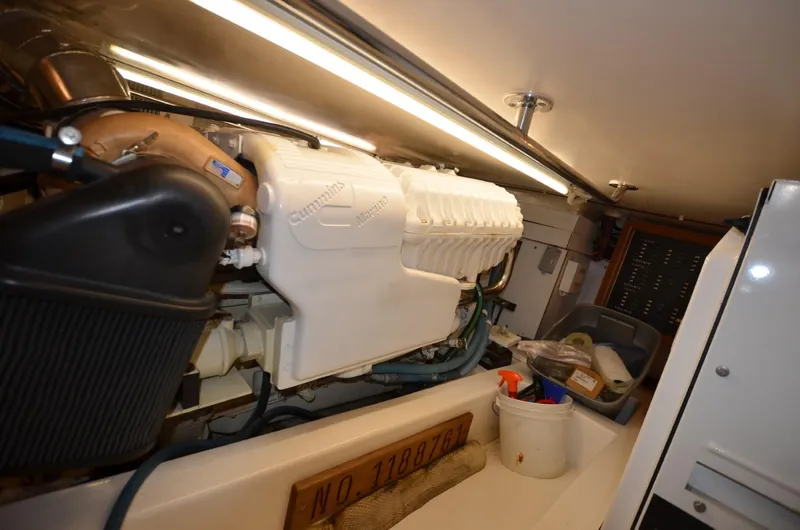 O Henry Yacht Photos Pics Engine room of 2006 Legacy Yachts Sedan, featuring a well-maintained engine and storage area.