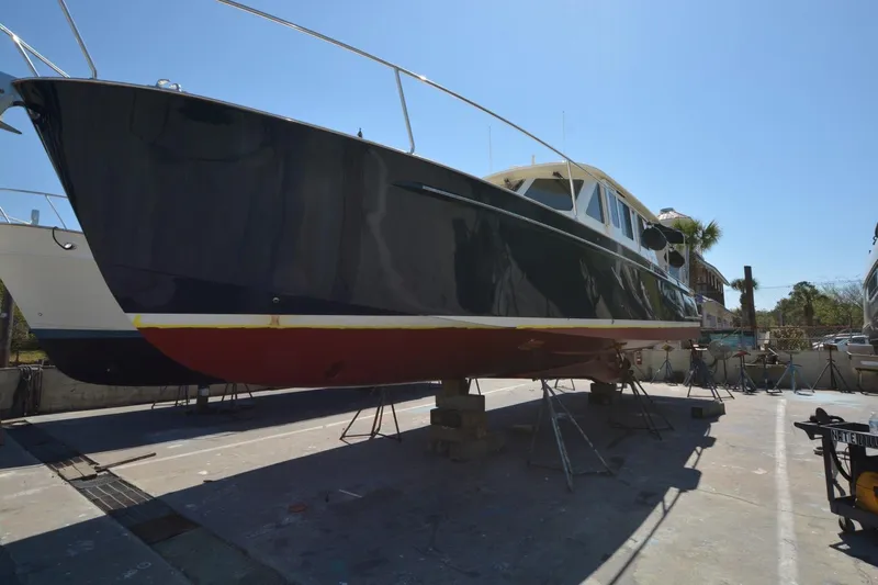 O Henry Yacht Photos Pics 2006 Legacy Yachts Sedan on dry dock, showcasing sleek design and craftsmanship.