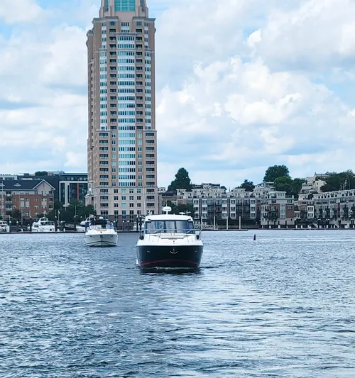 B Seaductive Yacht Photos Pics 2014 Regal 42 Sport Coupe yacht on water with cityscape and tall building backdrop.