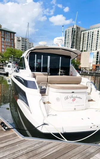 B Seaductive Yacht Photos Pics 2014 Regal 42 Sport Coupe docked in urban marina with modern buildings in background.