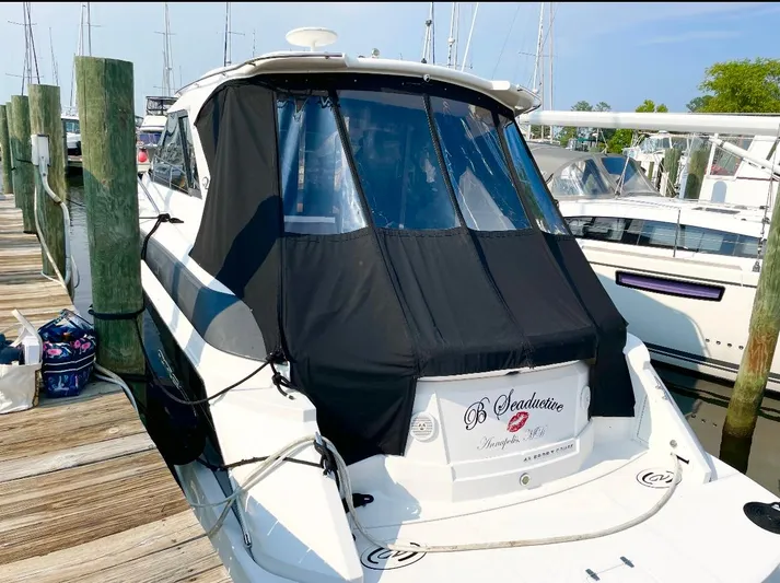 B Seaductive Yacht Photos Pics 2014 Regal 42 Sport Coupe docked at marina with black cover.