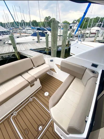 B Seaductive Yacht Photos Pics 2014 Regal 42 Sport Coupe with beige seating at a marina dock.
