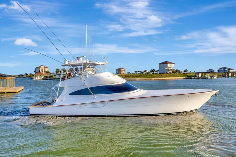 Desparado Yacht Photos Pics 2019 Viking 68 Convertible yacht cruising in a scenic coastal area.