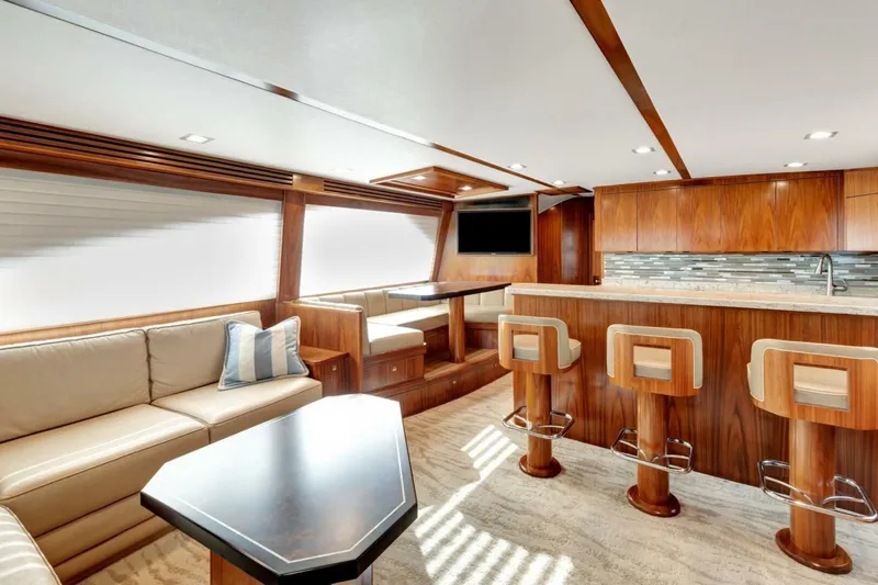 Desparado Yacht Photos Pics Luxurious interior of 2019 Viking 68 Convertible yacht with modern kitchen and seating area.