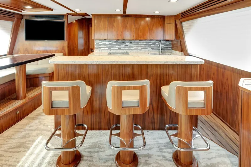 Desparado Yacht Photos Pics Luxurious interior of 2019 Viking 68 Convertible yacht with modern bar and seating.
