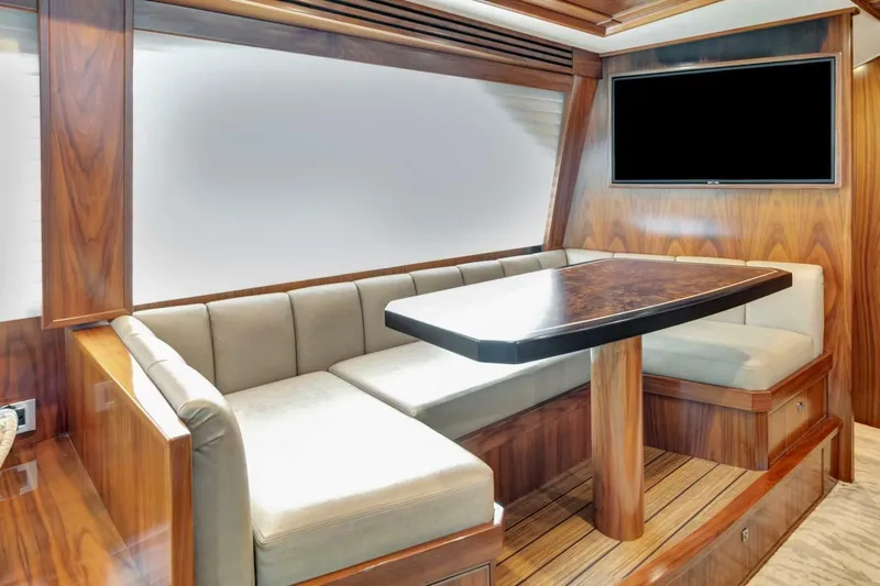 Desparado Yacht Photos Pics Luxurious interior of 2019 Viking 68 Convertible yacht with elegant wood finish and seating area.