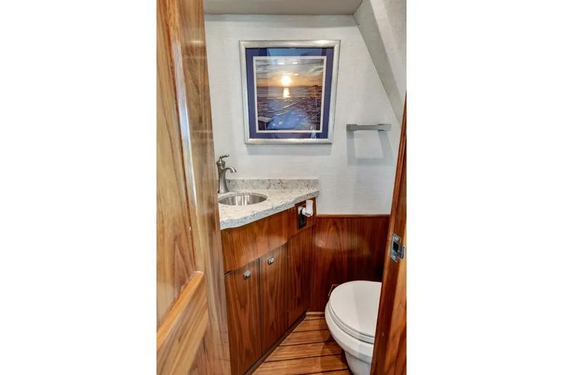 Desparado Yacht Photos Pics Luxurious bathroom in 2019 Viking 68 Convertible yacht with wood accents and modern fixtures.