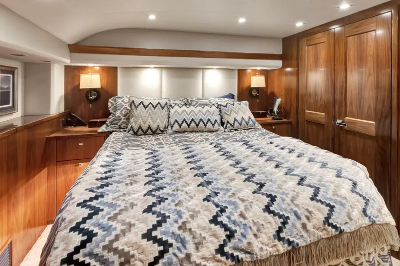 Desparado Yacht Photos Pics Luxurious bedroom interior of 2019 Viking 68 Convertible yacht with elegant wood finishes.