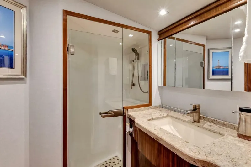 Desparado Yacht Photos Pics Luxurious bathroom in 2019 Viking 68 Convertible yacht with glass shower and elegant vanity.