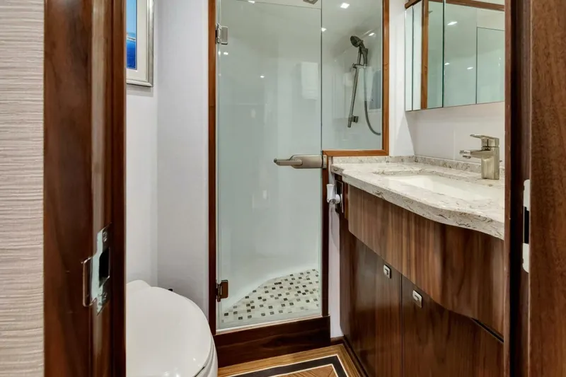 Desparado Yacht Photos Pics Luxurious bathroom in 2019 Viking 68 Convertible yacht with modern fixtures and wood accents.