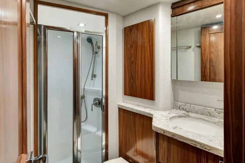 Desparado Yacht Photos Pics Luxurious bathroom in 2019 Viking 68 Convertible yacht with wood accents and modern shower.