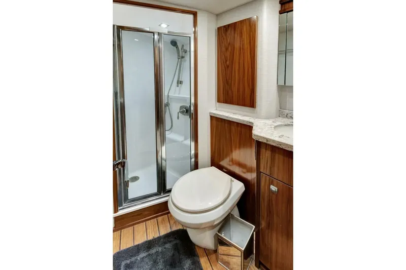 Desparado Yacht Photos Pics Luxurious bathroom in 2019 Viking 68 Convertible yacht with shower and wooden cabinetry.