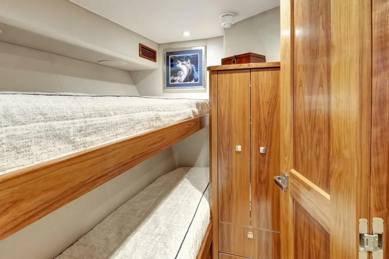 Desparado Yacht Photos Pics Interior of 2019 Viking 68 Convertible yacht with wooden bunk beds and cabinetry.