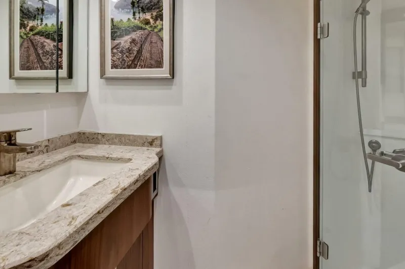 Desparado Yacht Photos Pics Luxurious bathroom in 2019 Viking 68 Convertible yacht with marble countertop and glass shower.