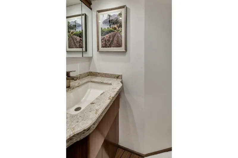 Desparado Yacht Photos Pics Luxurious bathroom in 2019 Viking 68 Convertible yacht with marble countertop and framed artwork.