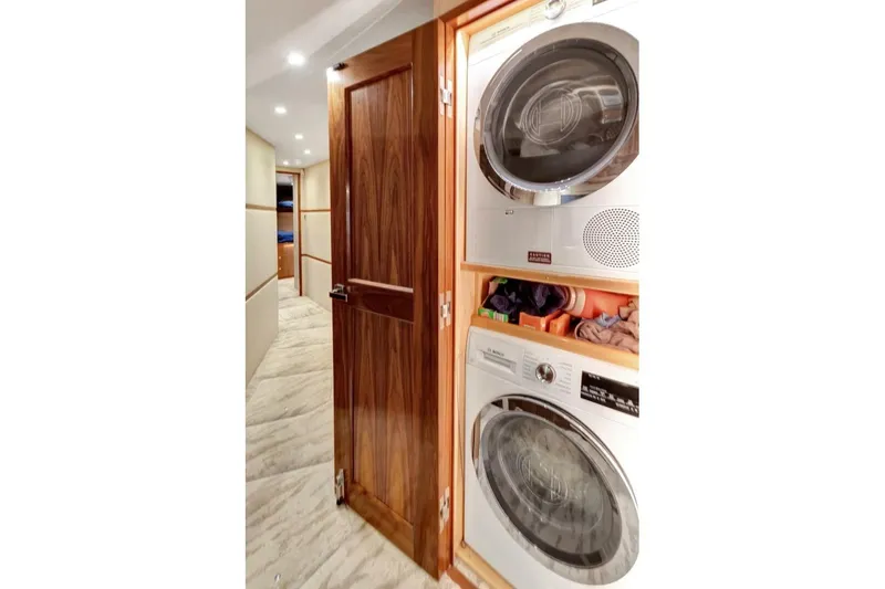 Desparado Yacht Photos Pics Laundry area inside 2019 Viking 68 Convertible yacht with stacked washer and dryer.