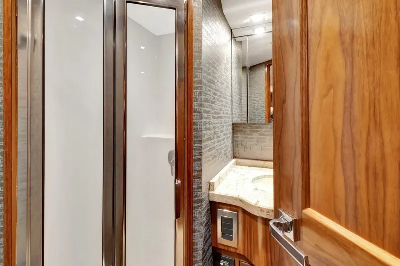 Desparado Yacht Photos Pics Luxurious bathroom in 2019 Viking 68 Convertible yacht with wood accents and modern fixtures.