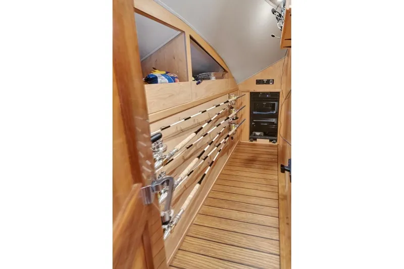 Desparado Yacht Photos Pics 2019 Viking 68 Convertible yacht interior with fishing rod storage and wooden flooring.