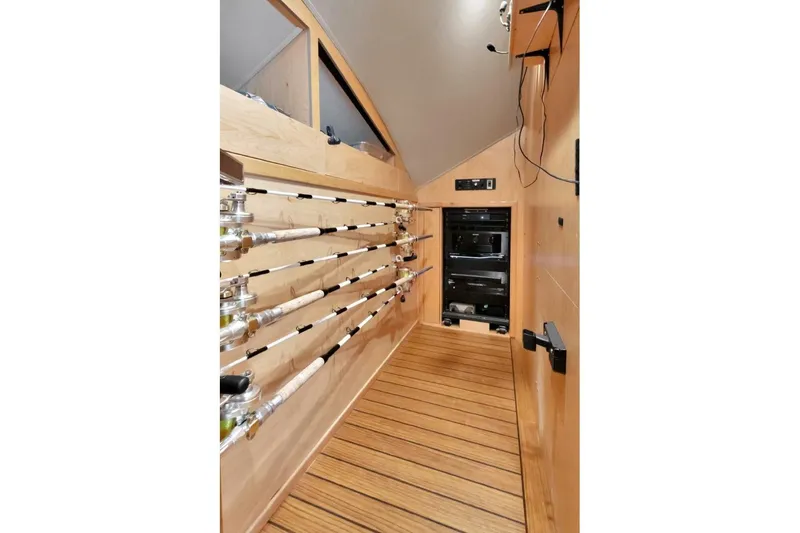 Desparado Yacht Photos Pics 2019 Viking 68 Convertible yacht interior with fishing rod storage and wooden flooring.